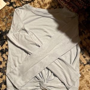 Blue long sleeve with a swirl at the bottom